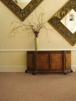 waterproof carpet in front entryway with carved wood buffet